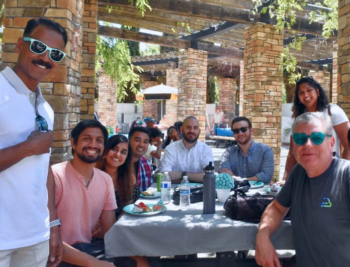 Tekion team bonding over lunch, highlighting employee culture at the cloud-native automotive tech company