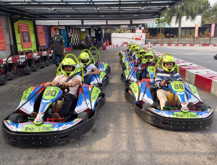 Tekion team enjoying a go-kart outing as part of employee engagement and company culture
