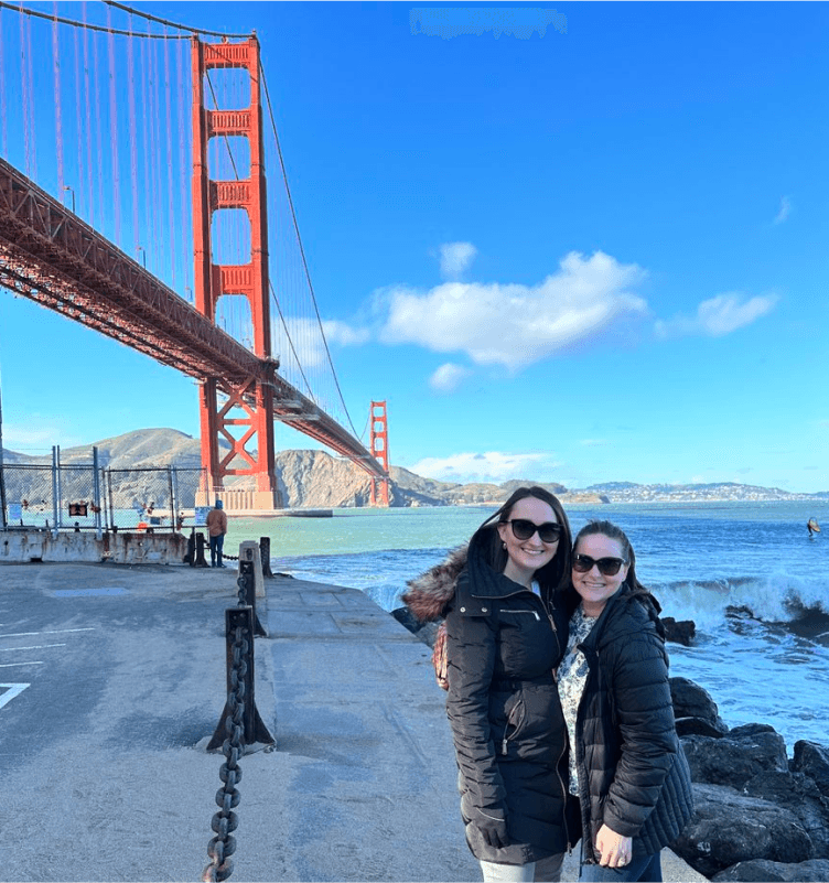 Tekion employees standing near the Golden Gate Bridge, symbolizing the company’s global impact in automotive retail technology