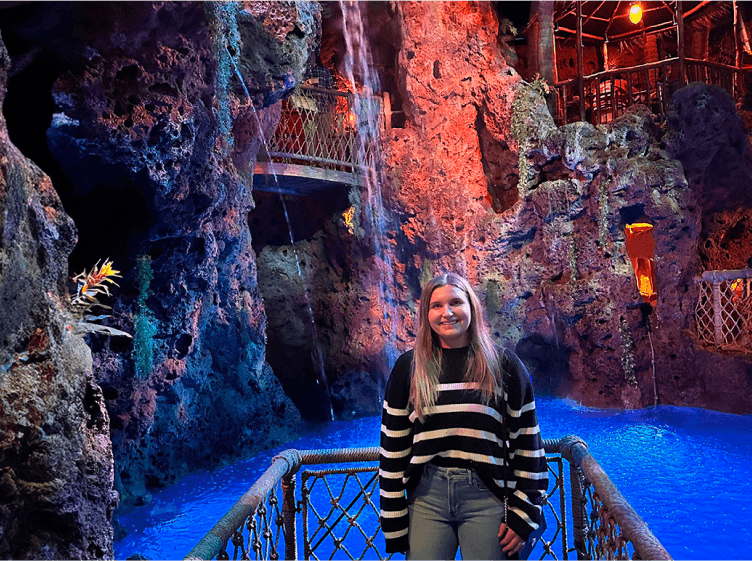 Tekion employee standing near a waterfall, embodying the fluidity and innovation of Tekion’s automotive solutions