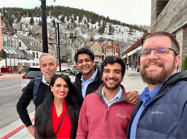 Tekion employees posing for a photo with snowy hills in the background, representing the company’s dynamic and diverse work culture