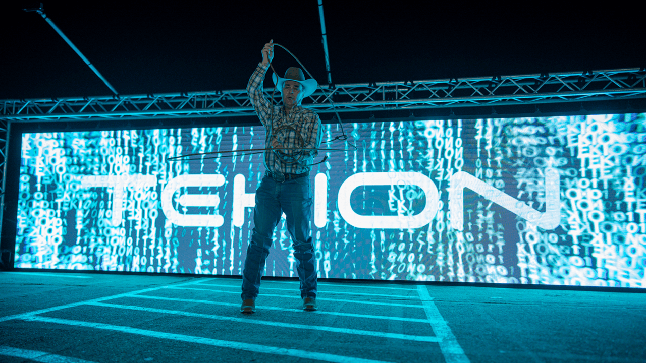 Tekion logo digitally illuminated at the NADA event, highlighting Tekion’s leadership in automotive cloud solutions